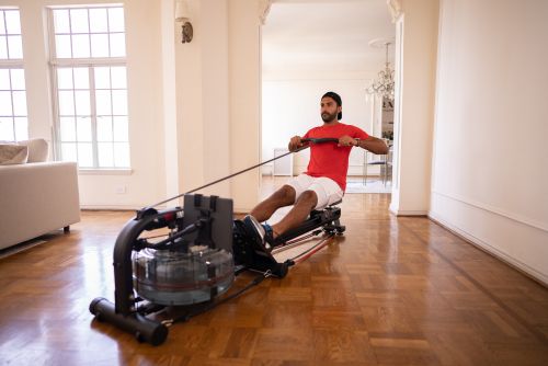 man using LIT Strength Machine at home