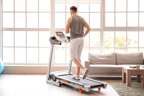 man working out on a treadmill without a mat under it