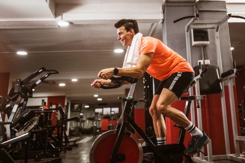 man cycling in a gym