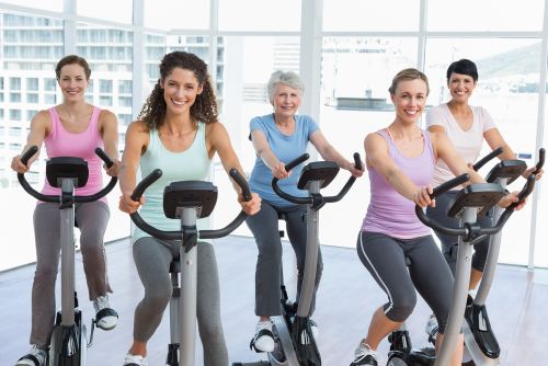 group of women using Foldable Exercise Bikes