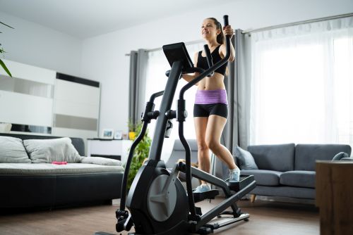 lady exercising to find out will elliptical help lose belly fat