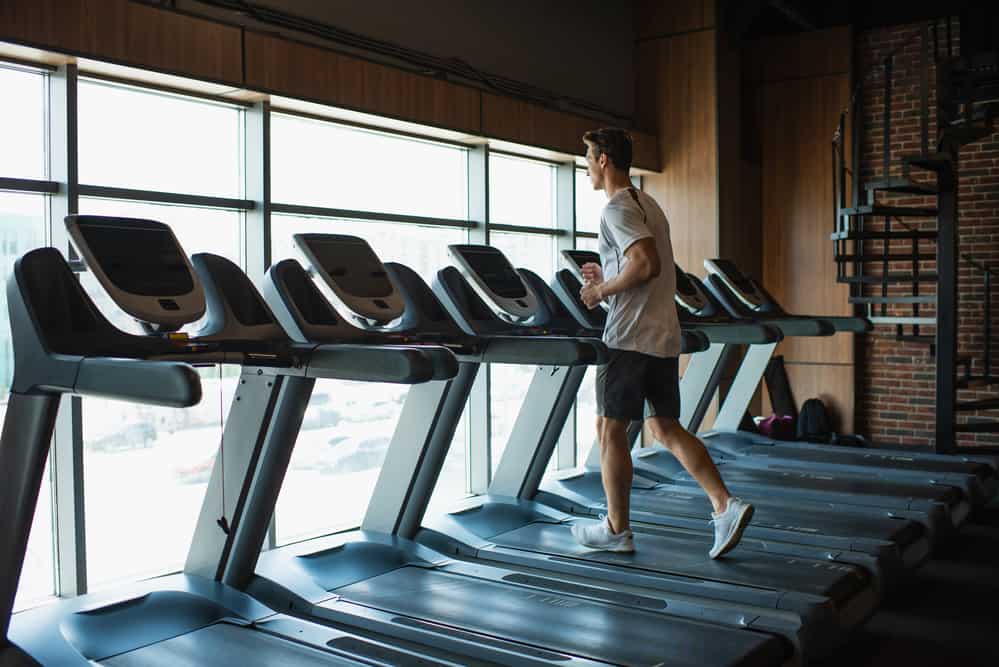 man trying to be safe on a treadmill at the gym