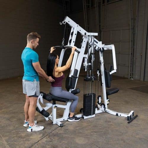 woman using Body Solid EXM2500S Home Gym 