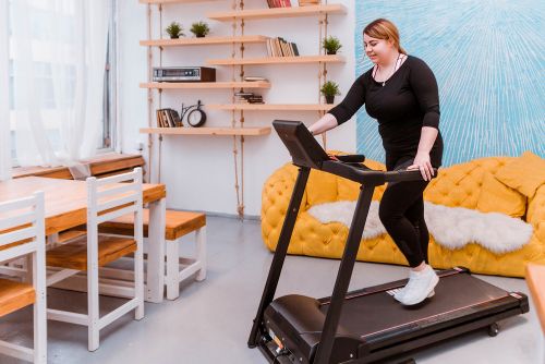 lady at home exercising on a home treadmill