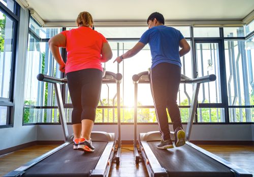 lady learning with trainer from couch to 5k on a home treadmill
