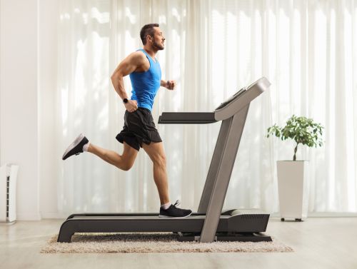man running one mile on a treadmill at home