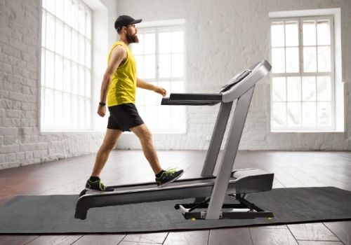 man showing you do you need a mat under your treadmill to help protect your floor