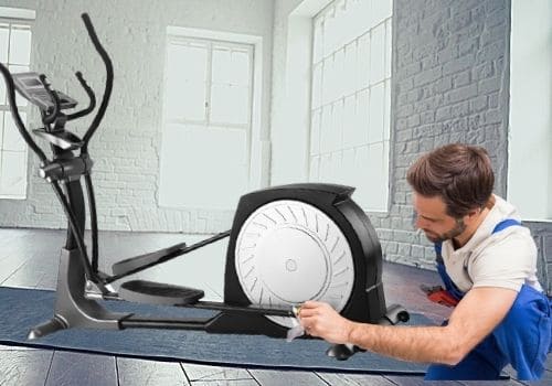 man showing how to dismantle an elliptical machine at home
