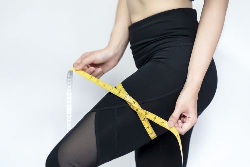 lady measuring thighs after running