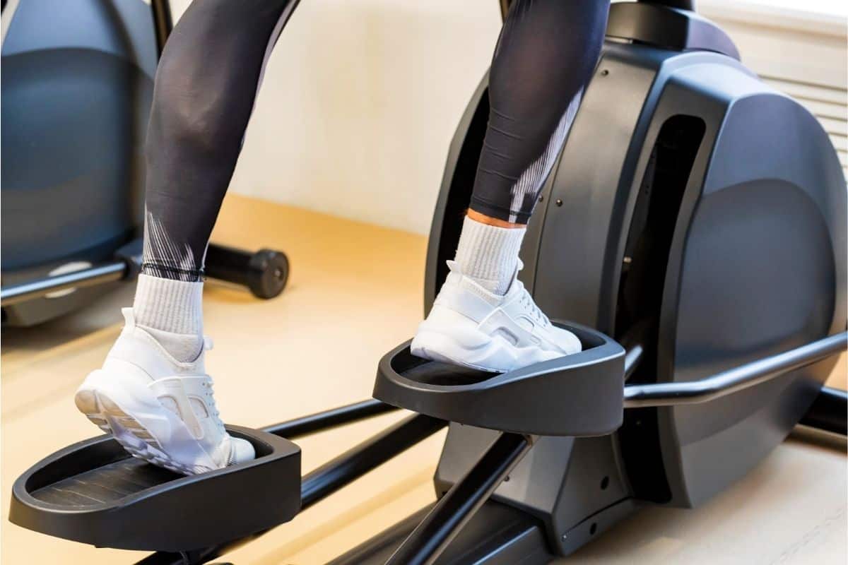 lady working out on an elliptical to slim her legs