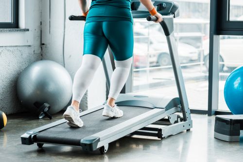 lower body of a person using an inclined treadmill