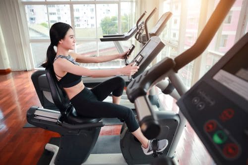 a girl working out on a recumbent bike