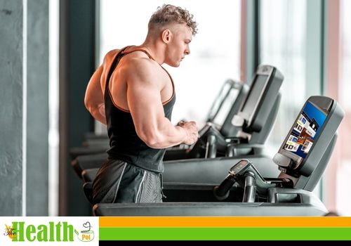 man watching TV while working out on a treadmill